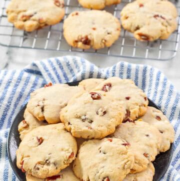 Copycat Keebler pecan sandies cookies on a plate and wire rack.