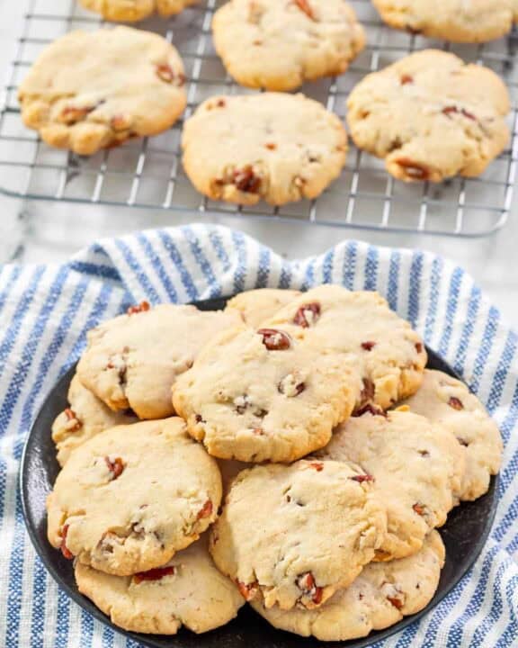 Copycat Keebler pecan sandies cookies on a plate and wire rack.