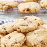 Homemade Keebler pecan sandies piled on a plate and on a wire rack.