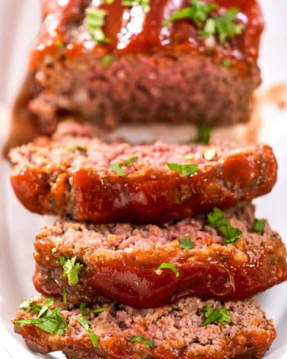 Mamma Joe's meatloaf on a platter and three slices cut from it.