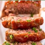 Three Mamma Joe's meatloaf slices in front of the loaf on a platter.