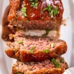 Mamma Joe's meatloaf on a platter and partially sliced.