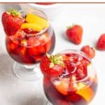 Two glasses of homemade Olive Garden sangria with strawberries and orange slices.