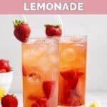 Homemade Red Robin freckled lemonade in two glasses garnished with strawberries.