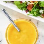 A salad and a small bowl of homemade Simon and Seafort's mustard dressing.