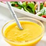 Homemade Simon and Seafort's mustard vinaigrette dressing in a small glass bowl.