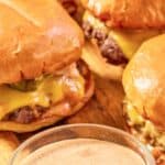 A bowl of homemade Sonic smasher sauce and smash burgers.