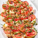 Copycat spaghetti warehouse caprese bruschetta on a marble surface.