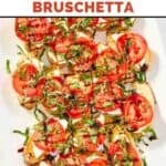 Homemade spaghetti warehouse caprese bruschetta on an oval platter.