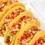 Homemade taco bell fresco style crunchy tacos on a platter.