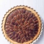 Homemade Taste of Texas pecan pie on a wood surface.