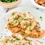 Homemade Texas Roadhouse smothered chicken on an oval platter.