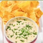 Homemade Applebee's queso blanco dip and tortilla chips on a platter.