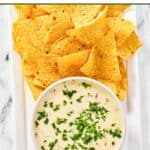 Homemade Applebee's queso blanco dip and tortilla chips on a platter.
