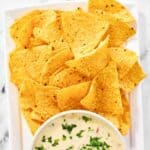 Homemade Applebee's queso blanco dip and chips on a platter.