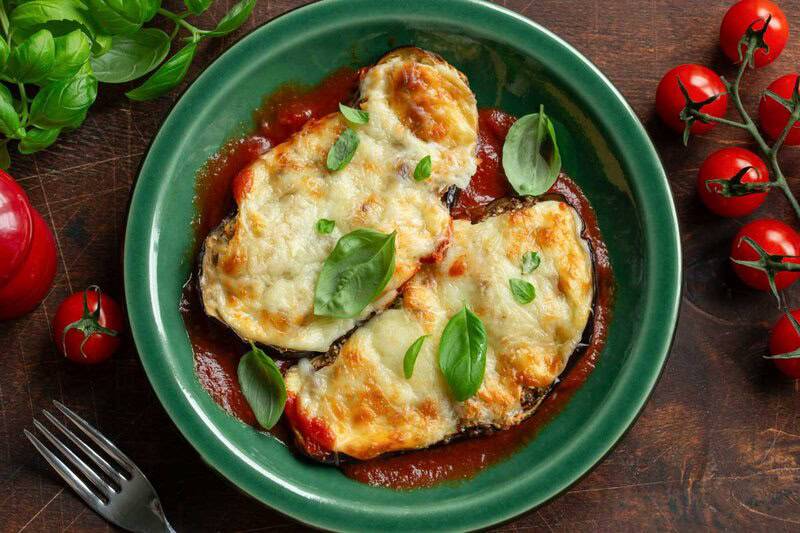 Eggplant parmesan, tomatoes, and fresh basil.