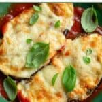 Two slices of eggplant parmesan on a plate.