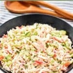 Homemade Golden Corral seafood salad in a large bowl and salad tongs behind it.