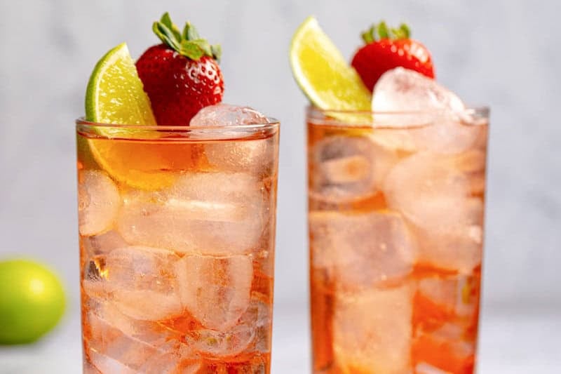 Copycat Sonic strawberry limeade garnished with lime and strawberry.