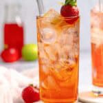 Copycat Sonic strawberry limeade in a tall glass on a coaster.