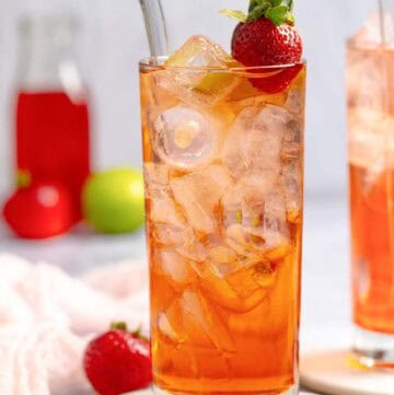 Copycat Sonic strawberry limeade in a tall glass on a coaster.