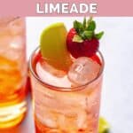 Homemade Sonic strawberry limeade garnished with a strawberry and lime wedge.