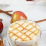 Copycat Starbucks apple crisp oatmilk macchiato, apple, and cinnamon sticks.