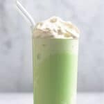 A homemade starbucks matcha frappuccino in a tall glass.