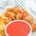 A bowl of homemade Chick-fil-A Polynesian sauce, chicken nuggets, and fries.