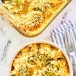 Copycat Cracker Barrel broccoli cheese casserole in a baking dish and a bowl.