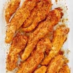 Ritz cracker chicken tenders in a glass baking dish.
