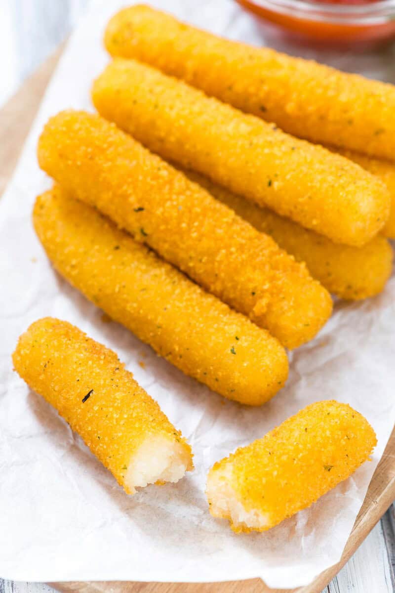 Smoked mozzarella sticks on parchment paper.
