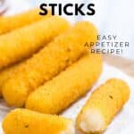 Homemade smoked mozzarella cheese sticks on parchment paper.